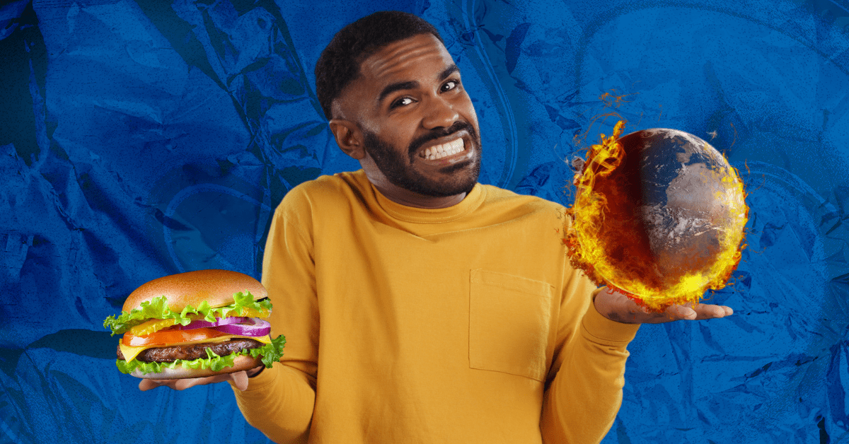 A man wearing a yellow shirt looks uncertain while weighing two options in each hand: a plant-based burger and a burning planet Earth.